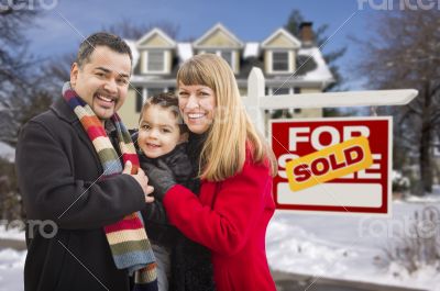 Family in Front of Sold Real Estate Sign and House