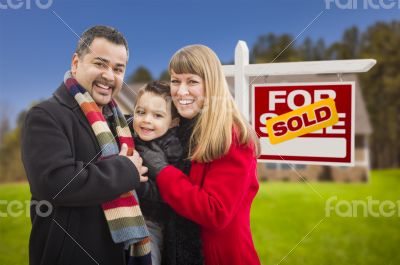 Family in Front of Sold Real Estate Sign and House