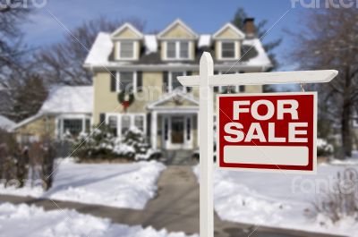 Home For Sale Sign in Front of Snowy New House Home For Sale Sign in Front of Snowy New House