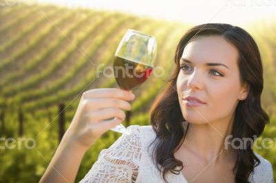 Young Adult Woman Enjoying A Glass of Wine in Vineyard