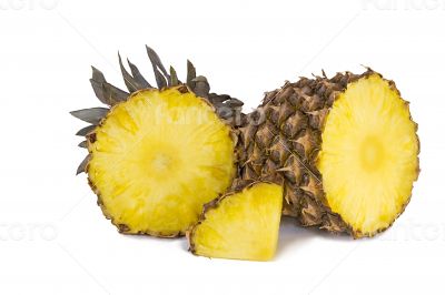 Pineapple and slices of pineapple on a white background.