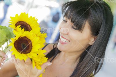 Pretty Italian Woman Looking at Sunflowers at Market