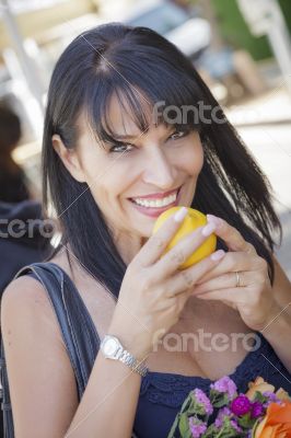 Pretty Italian Woman Smelling Oranges at the Street Market