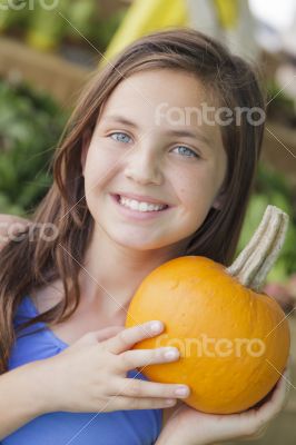 Pretty Young Girl Having Fun with the Pumpkins at Market