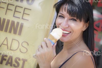 Pretty Italian Woman Enjoying Her Gelato at the Street Market. Pretty Italian Woman Enjoying Her Gelato at the Street Market.