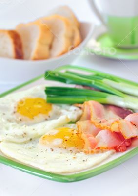 breakfast with bacon and fried eggs