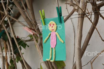 Child`s handmade small man on a green color paper Child`s handmade small man on a green color paper