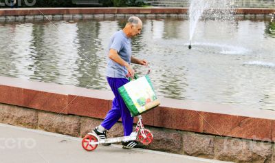 an old man in the Park near the fountain