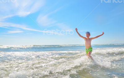 boy playing in waves