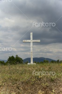 Old cross in the field.