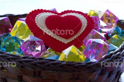 Decorative basket as heart with colored glass and a red heart.