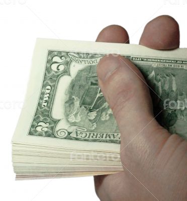 Mans hand holding a stacks of paper dollars USA on the white bac Mans hand holding a stacks of paper dollars USA on the white bac