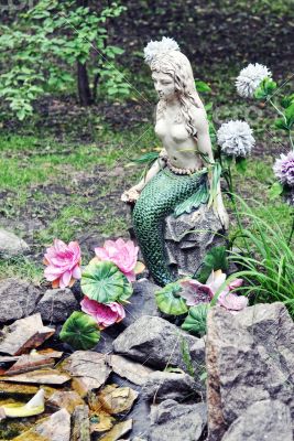 Mermaid sculpture sits