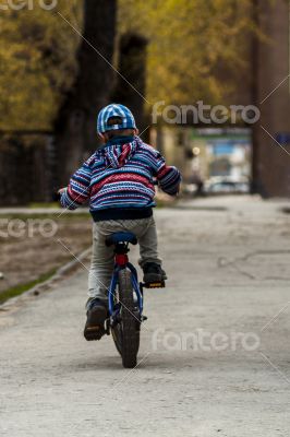 child rides a bicycle