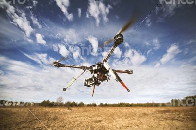 Quadrocopter drone flying in the sky