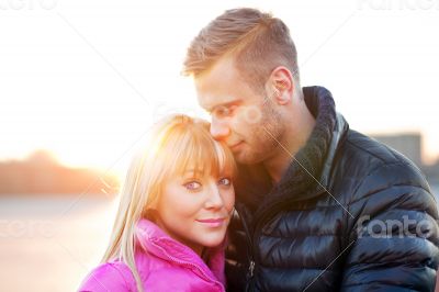 Young man embraces his girlfriend