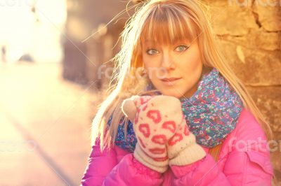 Woman warming her hands in mittens