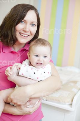 Happy mother and child in nursery