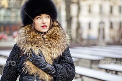 Winter girl posing in park