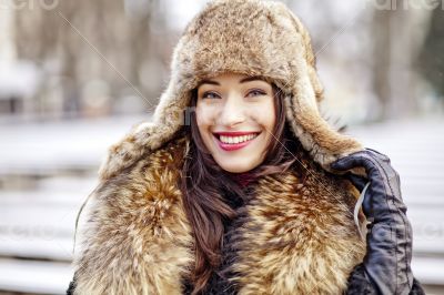 Girl smiling in fur hat and coat