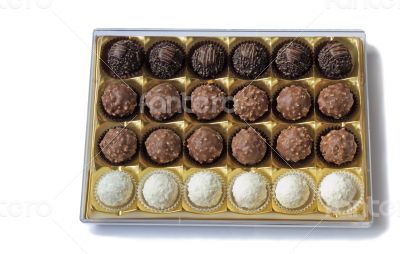 Chocolate sweets in the box on the white background.