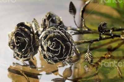 The shiny metal forged roses, handmade