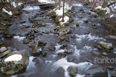 River bank and in clear water of stream. Winter is beginning at 