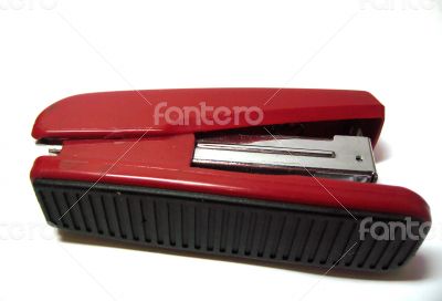 Red stapler isolated on the white background