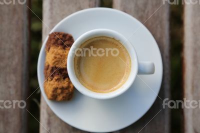 A cup of Italian espresso with a biscuit A cup of Italian espresso with a biscuit