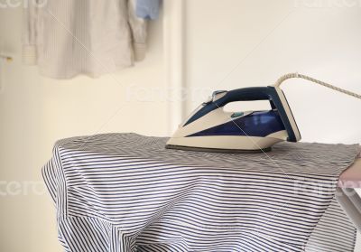 The shirt and the iron on the ironing board