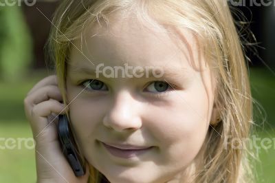 Cute girl talking by cellular