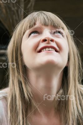 Blond woman looking upwards