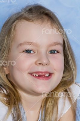 Smiling toothless girl with blond hair