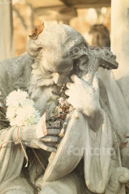 Beautiful Grave with an Old Man Statue in a Hungarian Cemetery