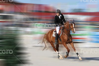 Pretty young girl walking on a horse competition at the riding.