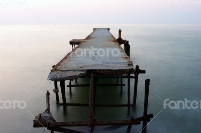 Abandoned concrete wharf in sea within sunrise Abandoned concrete wharf in sea within sunrise