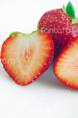 Healthy red strawberry fruit sliced isolated on the white backgr Healthy red strawberry fruit sliced isolated on the white backgr