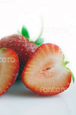 Healthy red strawberry fruit sliced isolated on the white backgr