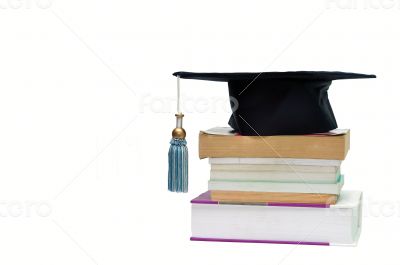 Graduation cap on top of a stack of books