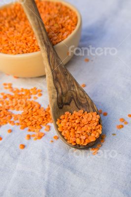 Dried orange lentils in the wooden spoon