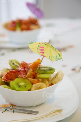 A white plate of fruit salad A white plate of fruit salad
