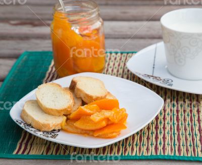 Homemade tangerine marmalade on the small square dessert plate