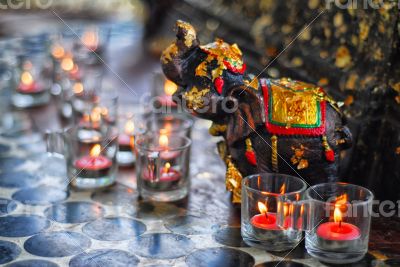 Candles with an elephant sculpture sacrifice
