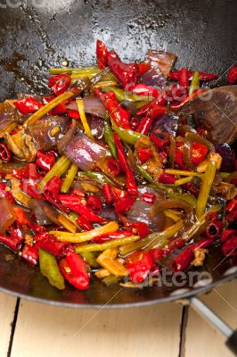 fried chili pepper and vegetable on a wok pan