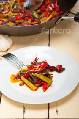 fried chili pepper and vegetable on a wok pan