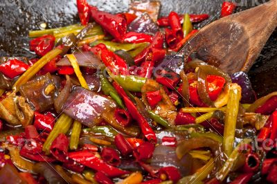 fried chili pepper and vegetable on a wok pan