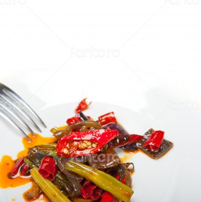 fried chili pepper and vegetable on a wok pan