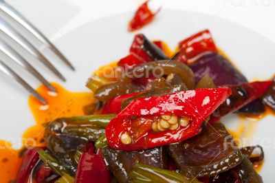 fried chili pepper and vegetable on a wok pan fried chili pepper and vegetable on a wok pan