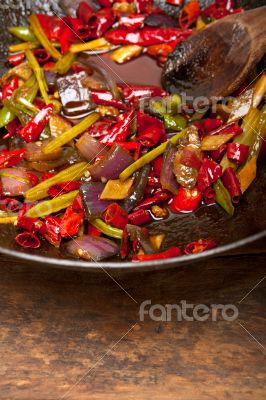 fried chili pepper and vegetable on a wok pan