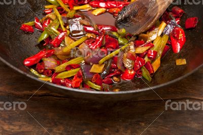 fried chili pepper and vegetable on a wok pan